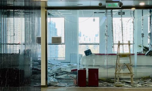 Bright and modern office in renovation with city skyline visible through large windows, ideal for construction themes.