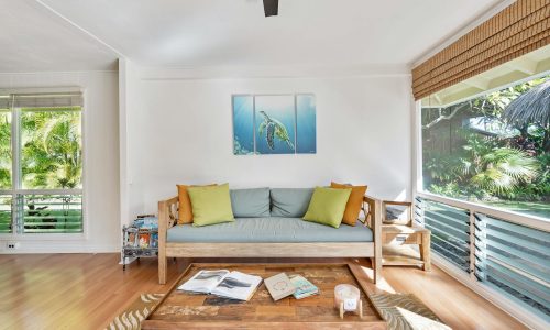 Stylish living room with natural light and nature view, perfect for relaxation.