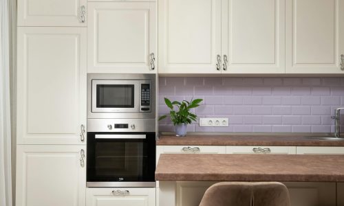 Stylish kitchen interior featuring cabinetry, built-in microwave, and elegant decor.